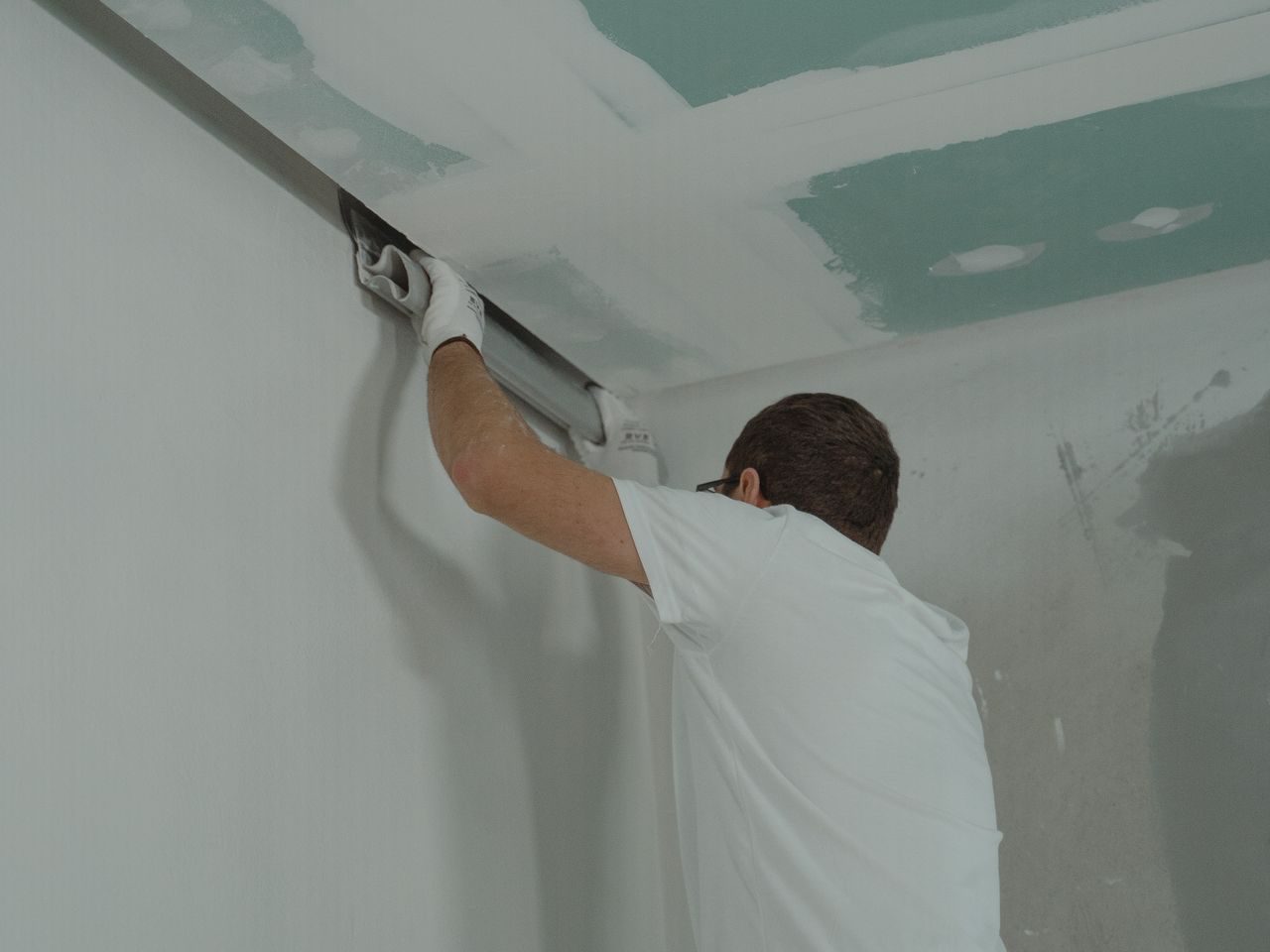 A young apprentice doing light construction work during a building renovation